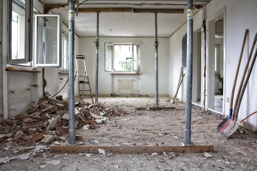 Room mid-remodel with tear-out debris and tools